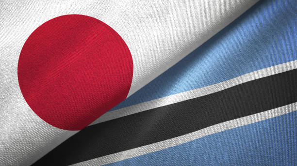 istock Botswana and Japan two flags together textile cloth, fabric texture 1124449599