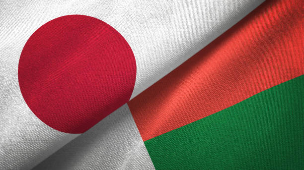 istock Madagascar and Japan two flags together textile cloth, fabric texture 1124449826