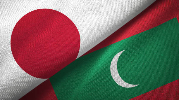 istock Maldives and Japan two flags together textile cloth, fabric texture 1124449872
