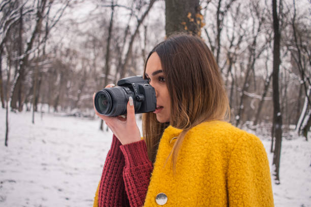 istock Woman photographing snow 1124450845