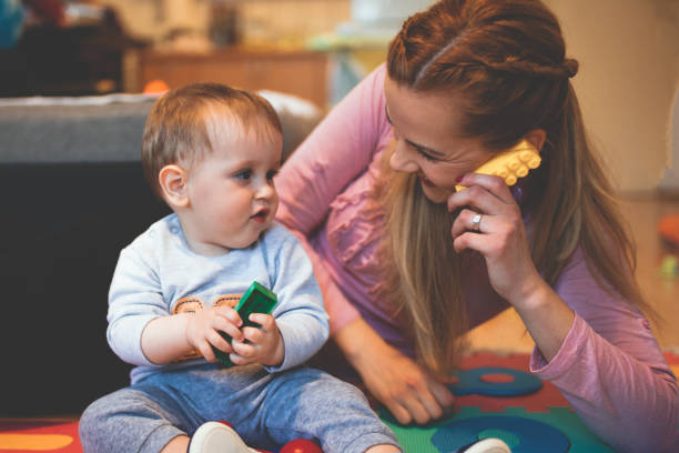 istock Baby boy playing with her mother 1124454646