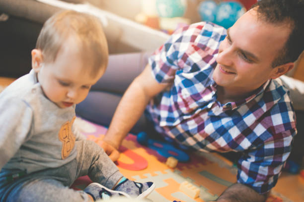 istock Baby boy playing with her father 1124454739