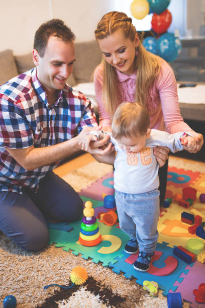 istock Baby boy playing with her parents 1124454845