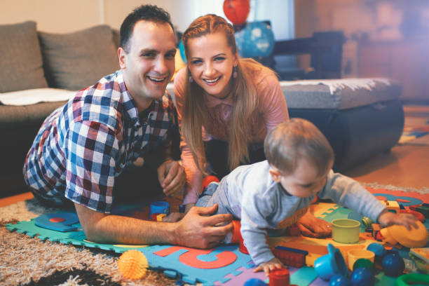 istock Baby boy playing with her parents 1124455077