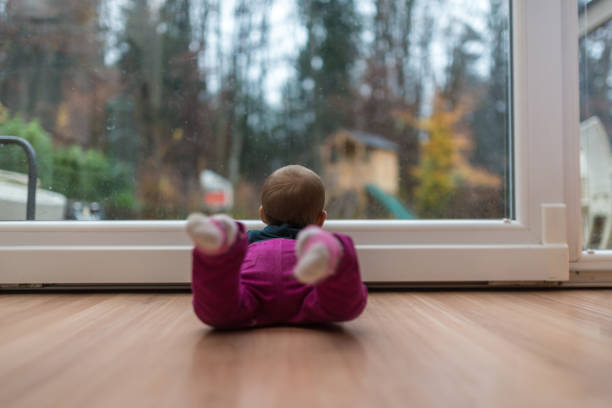 istock Baby girl looking out the window 1124456815