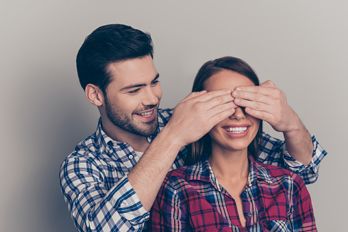 Closeup photo of beautiful attractive pretty charming nice with toothy beaming smile she her hiding eyes behind  handsome he his isolated grey background