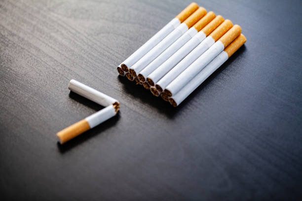 istock Stop smoking concept on background with broken cigarettes. Heap of cigarettes. No smoking 1124460664