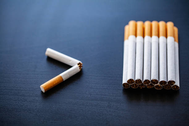 istock Stop smoking concept on background with broken cigarettes. Heap of cigarettes. No smoking 1124460775