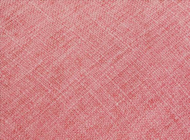 istock coral color on fabric, with visible texture. 1124461350