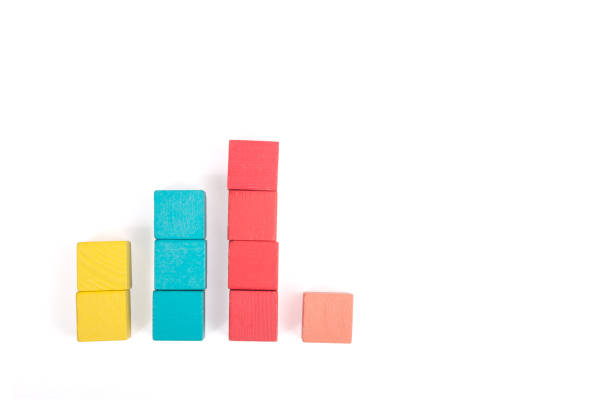 istock Toy wooden blocks as financial graph. Graph with four 4 steps. Growing chart. Infographic diagram, chart over grey or black or dark background. Multi-colored wooden blocks. 1124463413