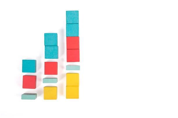 istock Toy wooden blocks as financial graph. Graph with four 4 steps. Growing chart. Infographic diagram, chart over grey or black or dark background. Multi-colored wooden blocks. 1124463457