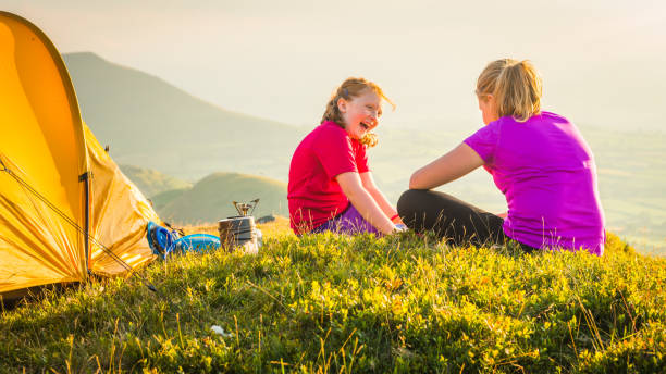 istock Children laughing camping on idyllic summer mountain sunset tent camp 1124465660