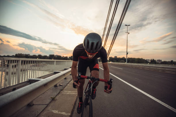 istock Cyclist guy riding his bicycle on the bridge 1124467135