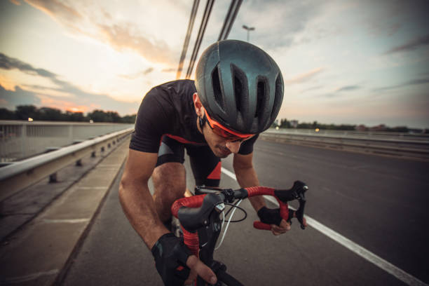 istock Man riding racing bicycle on street 1124469778