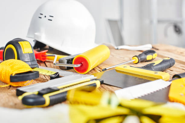 istock Home repairs. Construction tools, bricks and helmet on the wooden table 1124471827