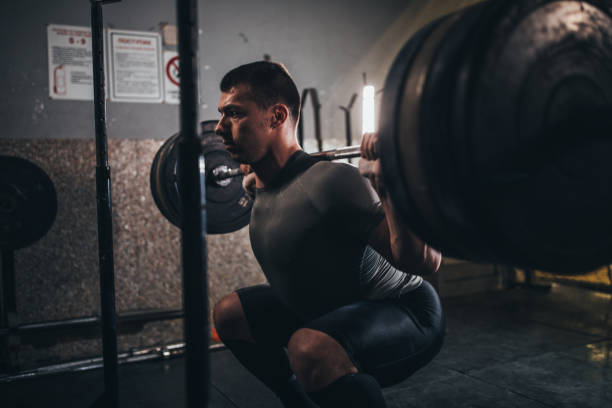 istock Man deadlifting barbell in gym 1124471857