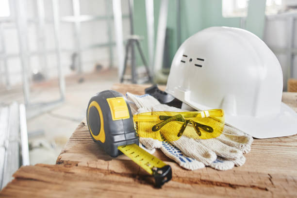 istock Home repairs. Construction tools, bricks and helmet on the wooden table 1124472675