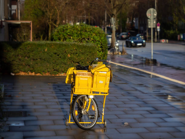 A yellow bicycle from the postman, alone in the street