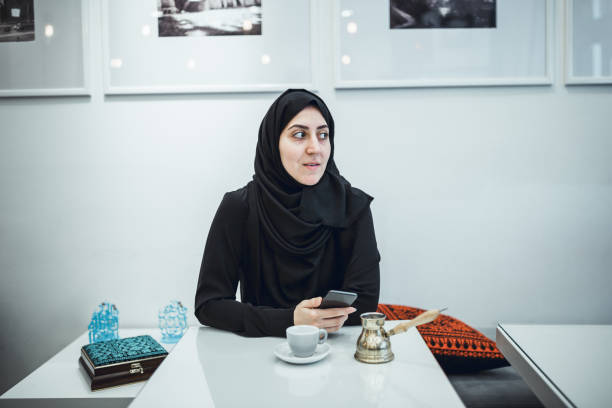 istock Muslim young woman working at cafe 1124475157