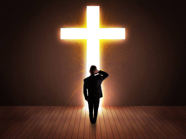 istock Man looking at bright cross sign 1124475181