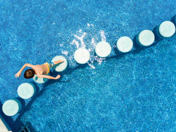 istock Kids Swimming in a pool 1124476738