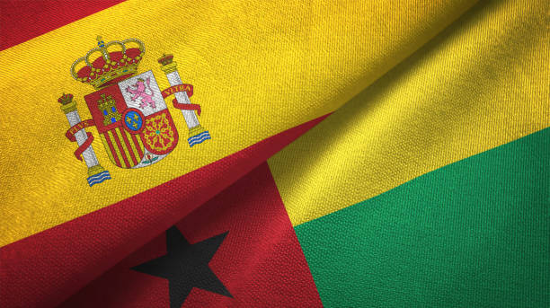 istock Guinea-Bissau and Spain two flags together textile cloth, fabric texture 1124477663