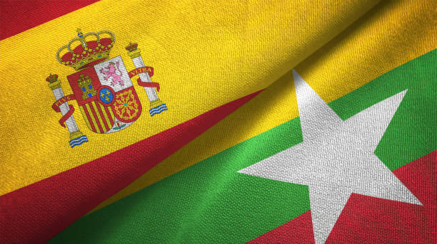 istock Myanmar and Spain two flags together textile cloth, fabric texture 1124477825