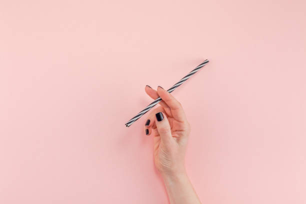 istock Woman hand with cocktail drinking straw 1124479143