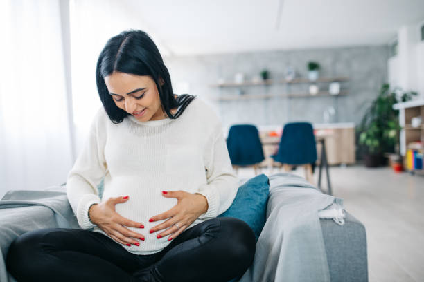 istock Pregnant woman holding her belly 1124479144