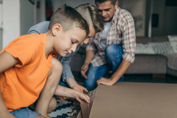 istock Single father is assembling furniture with his kids 1124479287