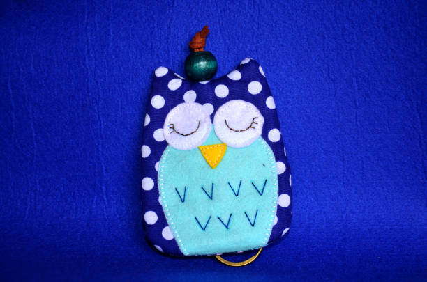 istock DIY handmade key cover owl doll pattern made from colorful fabric and leather and plastic beads in workshop thai style 1124479949
