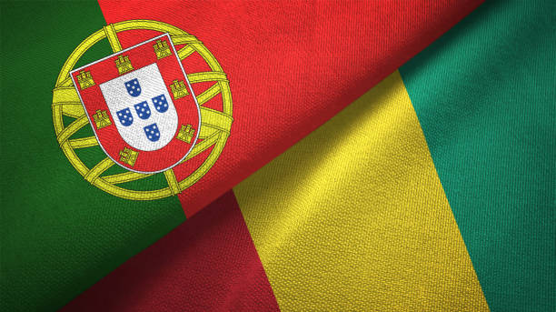 istock Guinea and Portugal two flags together textile cloth, fabric texture 1124480109