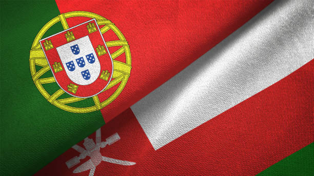 istock Oman and Portugal two flags together textile cloth, fabric texture 1124481797