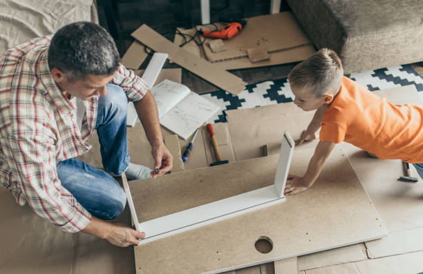 istock Single father is assembling furniture with his kids 1124482510