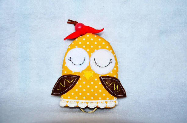 istock DIY handmade key cover owl doll pattern made from colorful fabric and leather and plastic beads in workshop thai style 1124484727