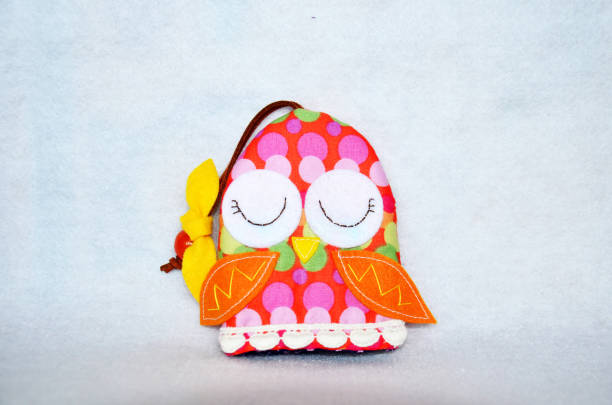 istock DIY handmade key cover owl doll pattern made from colorful fabric and leather and plastic beads in workshop thai style 1124485488