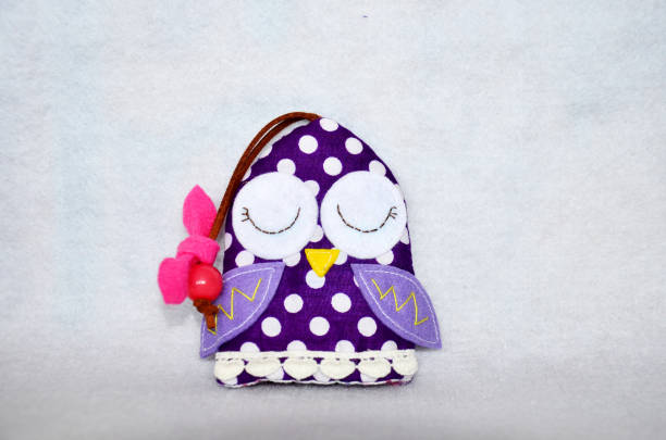 istock DIY handmade key cover owl doll pattern made from colorful fabric and leather and plastic beads in workshop thai style 1124485508