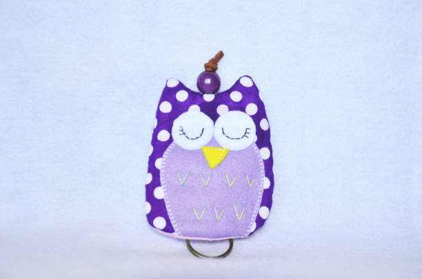 istock DIY handmade key cover owl doll pattern made from colorful fabric and leather and plastic beads in workshop thai style 1124486193