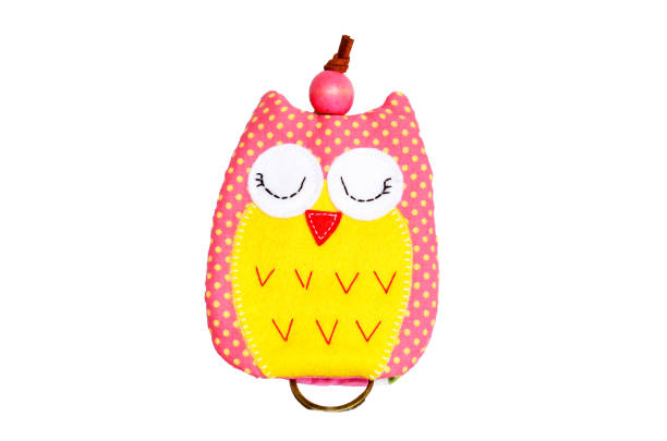 istock DIY handmade key cover owl doll pattern made from colorful fabric and leather and plastic beads in workshop thai style 1124486243