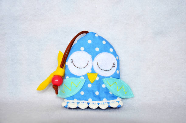 istock DIY handmade key cover owl doll pattern made from colorful fabric and leather and plastic beads in workshop thai style 1124486304