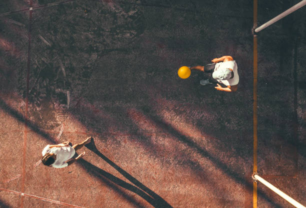 istock drone view on man playing soccer with teengage girl 1124486737