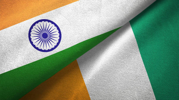istock Cote d'Ivoire Ivory coast and India two flags together textile cloth, fabric texture 1124487088