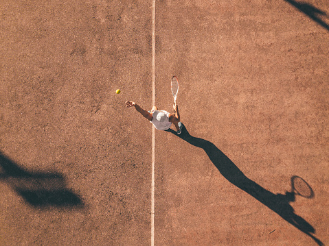 Drone view over tennis court with men playing