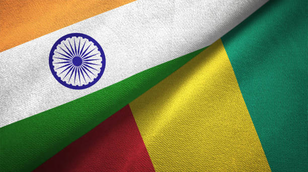 istock Guinea and India two flags together textile cloth, fabric texture 1124487746