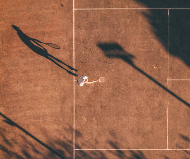 istock drone view on tennis player smashing the ball 1124487814