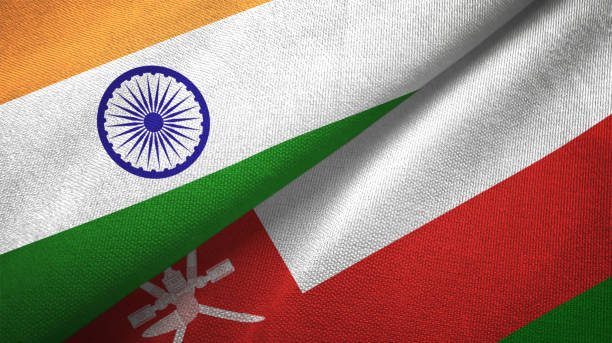 istock Oman and India two flags together textile cloth, fabric texture 1124487822
