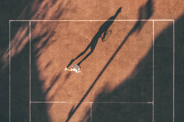drone view over tennis player awaiting the service