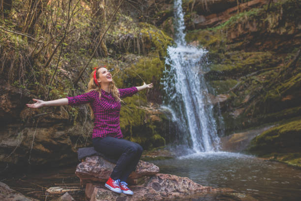 donna rilassarsi sul fiume - waterfall zen like women meditating foto e immagini stock