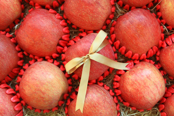 Red apples gift set with golden ribbon. Top view.