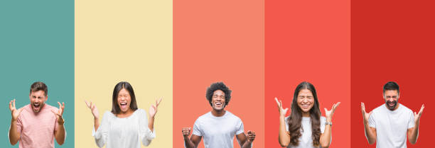 istock Collage of different ethnics young people over colorful stripes isolated background celebrating mad and crazy for success with arms raised and closed eyes screaming excited. Winner concept 1124489149